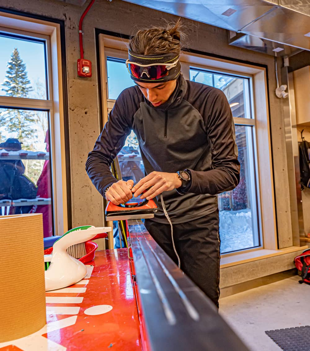 Fartage de ski par un technicien dans un atelier lumineux avec outils